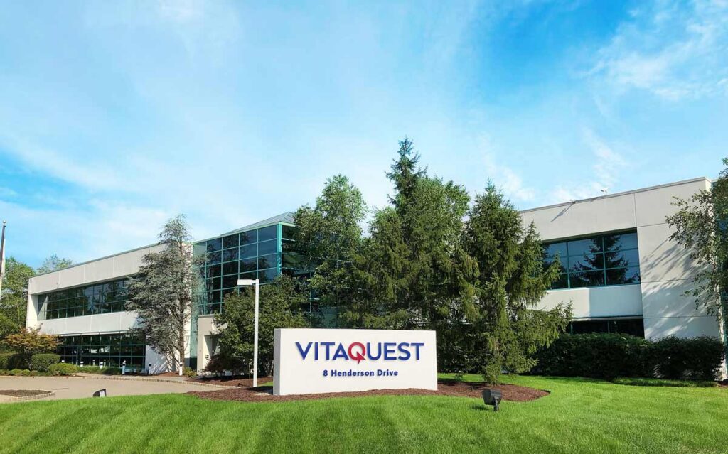 The exterior of Vitaquest's West Caldwell, headquarters building with the company signboard at 8 Henderson Drive.