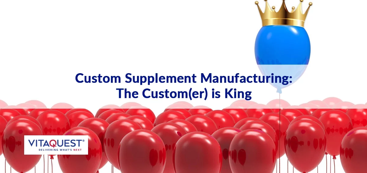 a single blue balloon wearing a crown, above a group of red balloons