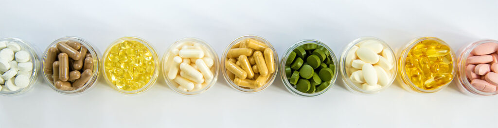 Supplements and vitamins on a white background. Selective focus. Medicine.
