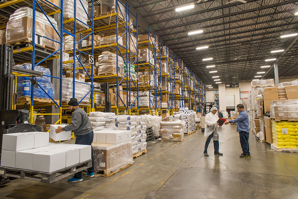 Large Vitaquest Warehouse active business work day with ingredients and orders for custom formulated manufacturing of vitamin supplements and nutraceuticals