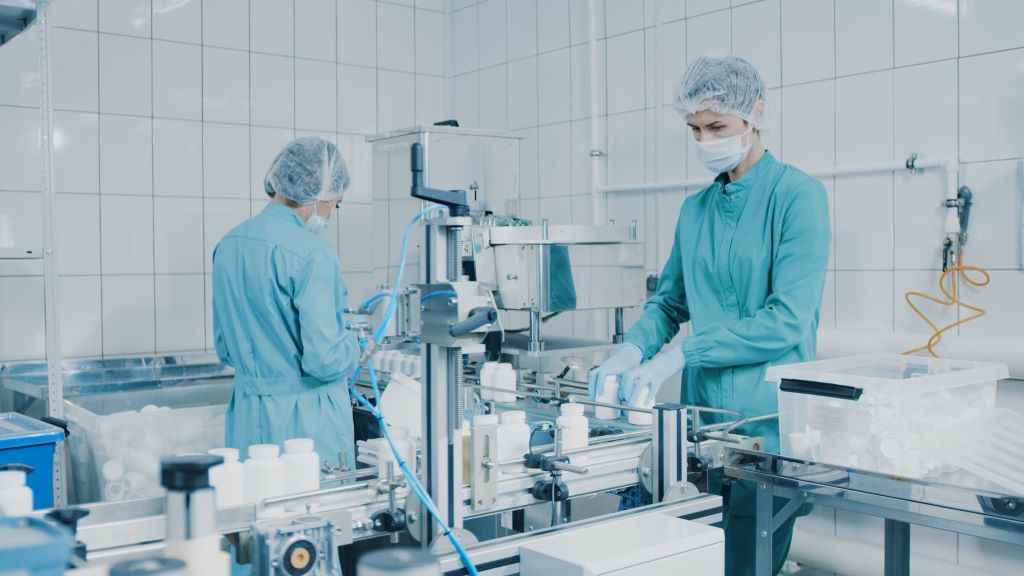 Employees working in a supplement manufacturing lab facility.