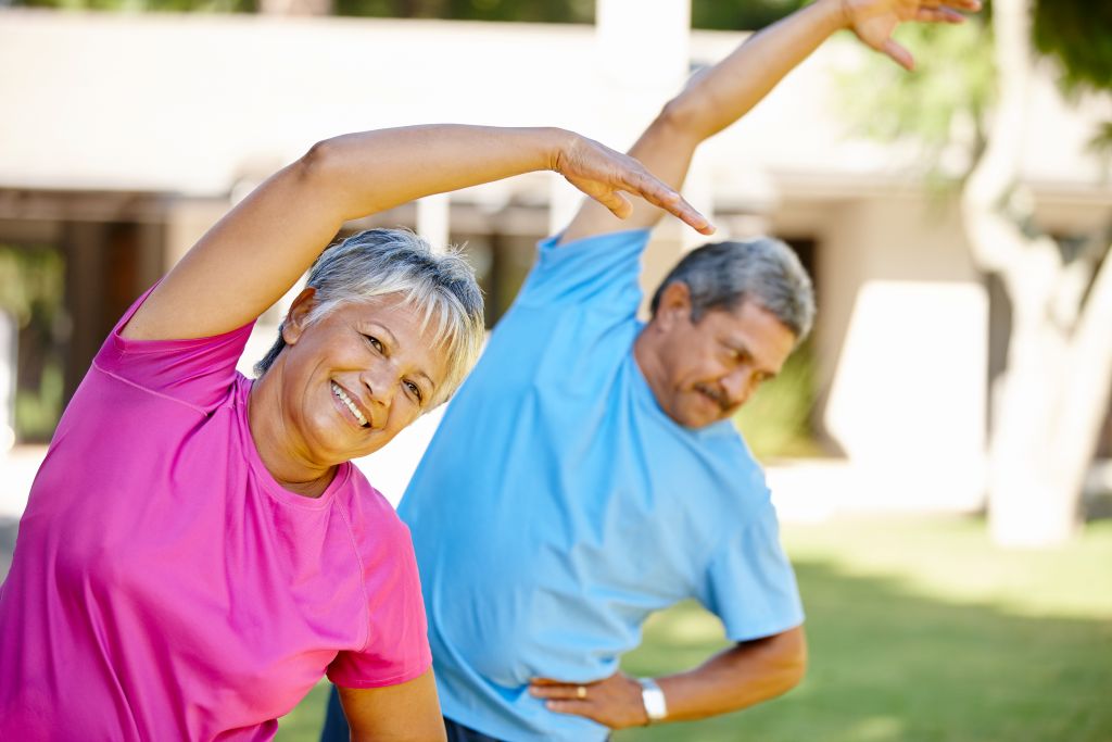 An older man and woman stretching. Our article answers the foundational question, "What is an NAD supplement?"