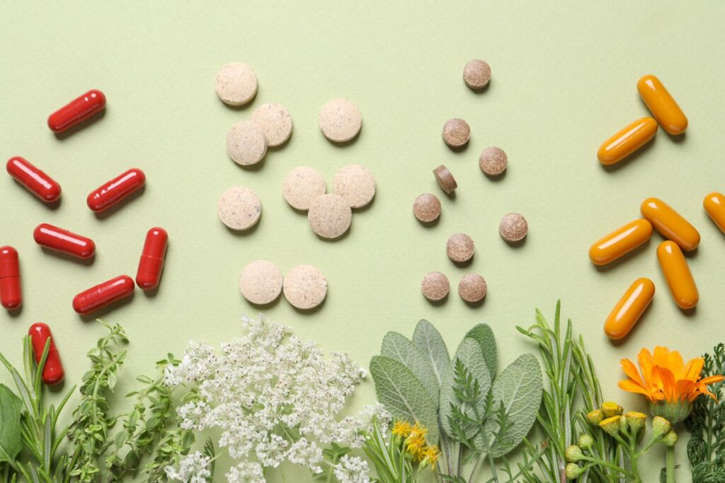 Non-GMO vs. Organic dietary supplements including capsules, tablets, and botanicals arranged side by side.