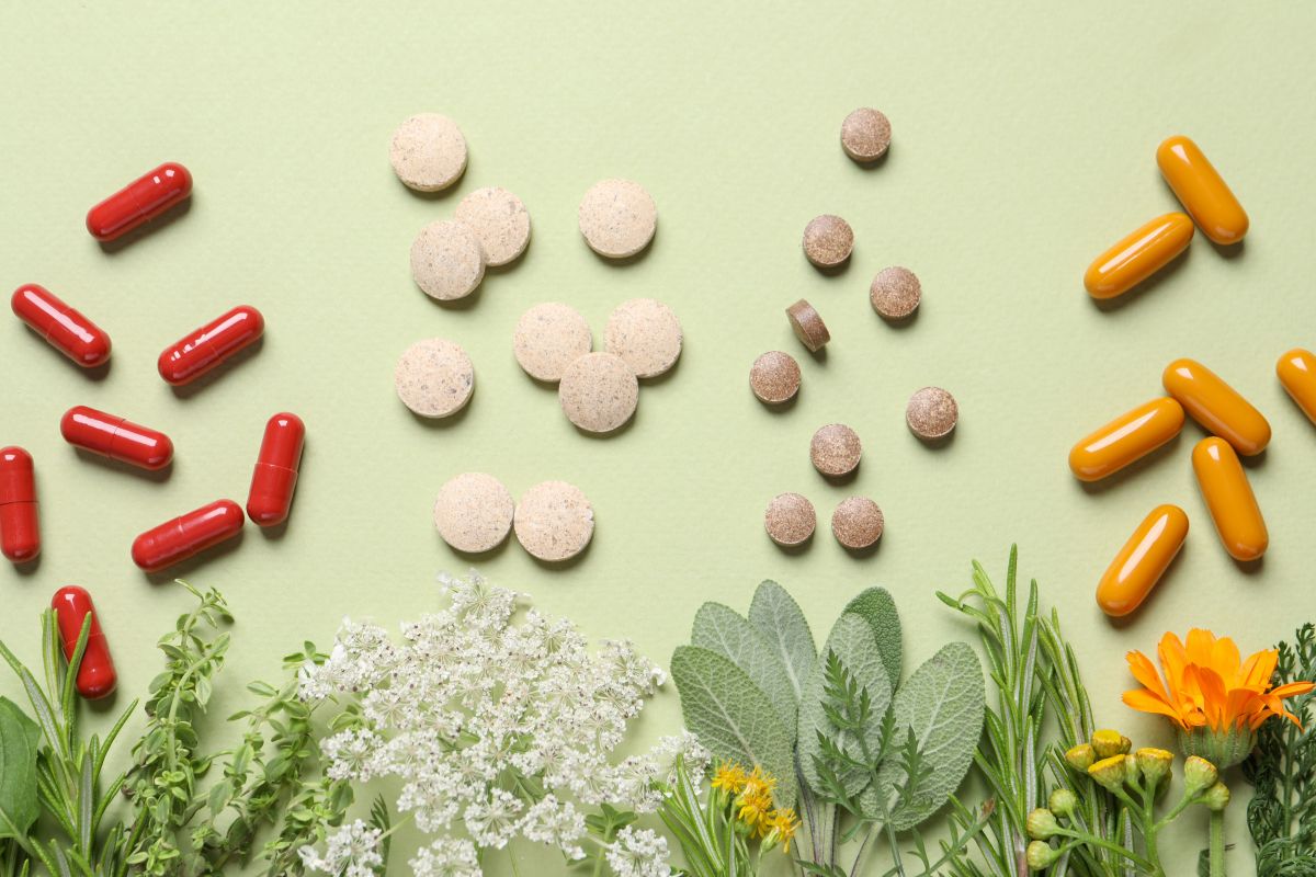 Non-GMO vs. Organic dietary supplements including capsules, tablets, and botanicals arranged side by side.
