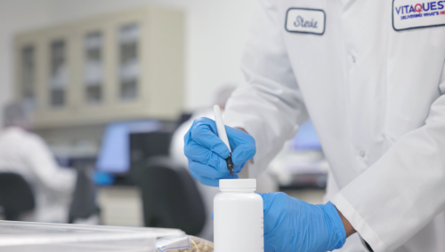Lab technician performing quality testing to support third-party supplement certification during dietary supplement manufacturing at Vitaquest.