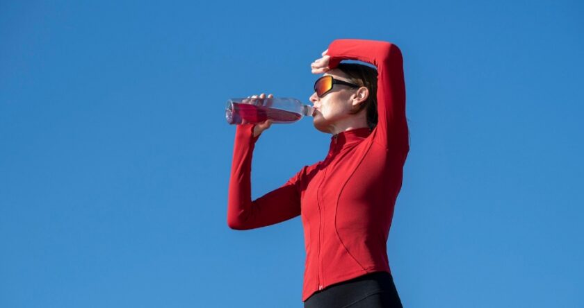Hydration supplement flavor trends illustrated by a woman taking a hydration break outdoors.