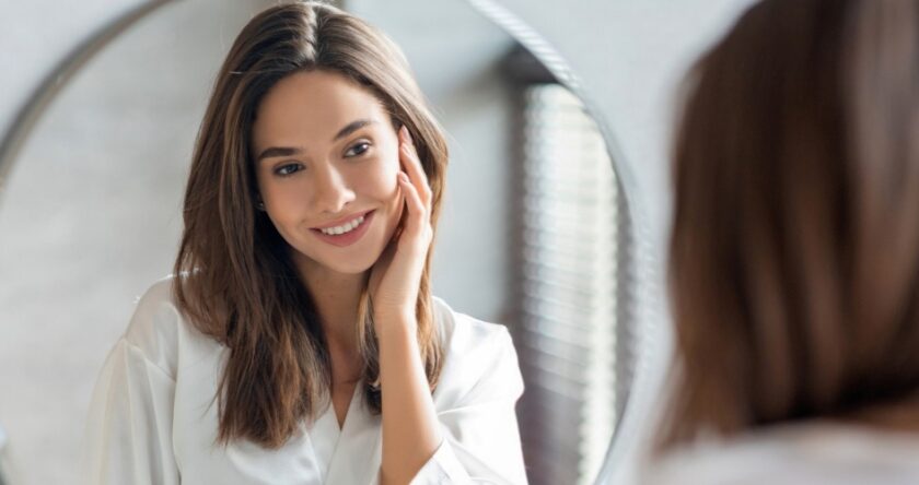 Woman looking at her reflection in a beauty image exploring what are nutricosmetics