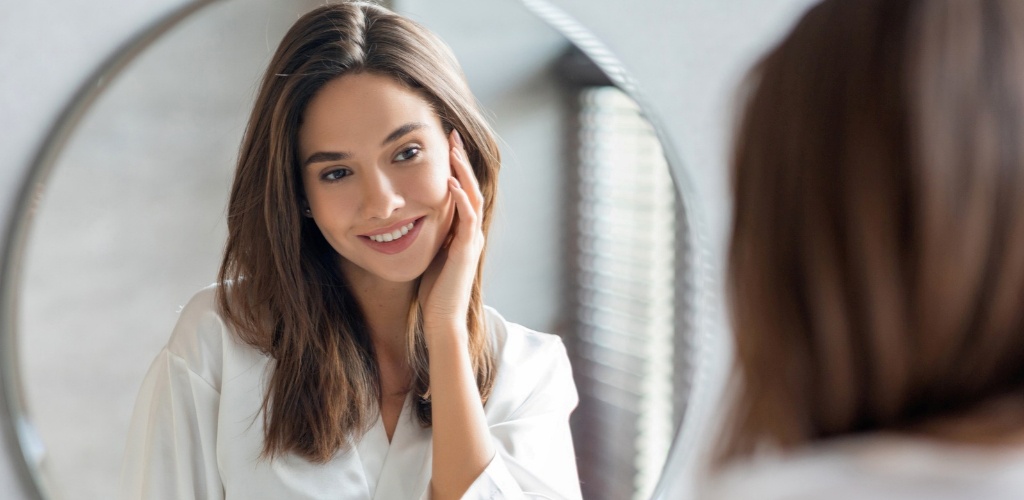 Woman looking at her reflection in a beauty image exploring what are nutricosmetics